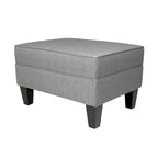 Pouf quadrato rivestito in tessuto con profilo saldato