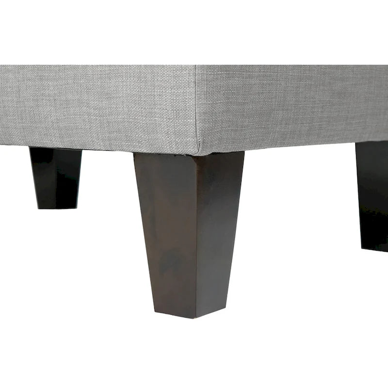 Pouf quadrato rivestito in tessuto con profilo saldato