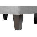 Pouf quadrato rivestito in tessuto con profilo saldato